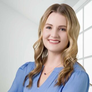 Professional Headshot of a health care professional with long blond hair and a warm expression
